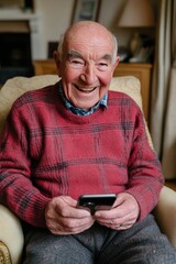Smiling Senior Man Enjoys Smartphone at Home, a Moment of Senior Joy and Tech Connection.