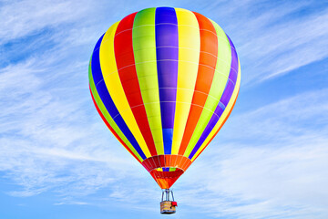 Fototapeta premium Colorful hot air balloon flying over blue sky with white clouds 