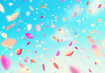Colorful petals falling against bright blue sky, creating dreamy atmosphere. Perfect for spring themes and celebrations