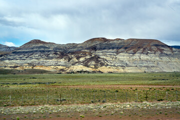 Fototapeta premium Beautiful landscape with cloudy blue sky and mountains in the background in the boundless lands of Argentine Patagonia