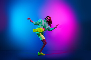 Obraz premium Full length photo of charming positive woman wear green sweatshirt fighting karate isolated neon blue color background