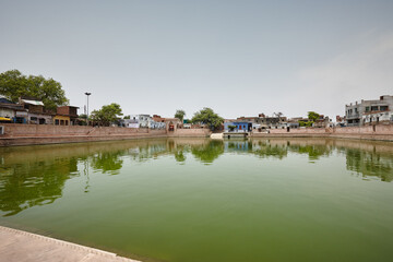 Sacred pool, nature and water with religion, belief and buildings in India, worship and travel....