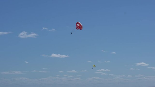 Aerial view following parasailers in sunny Cancun, Mexico