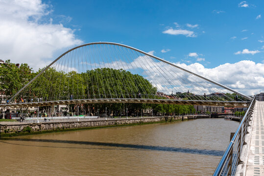 Bilbao, Spain - Mai 16, 2024 - Iconic Zubizuri Bridge spans over the tranquil Nervion river in Bilbao