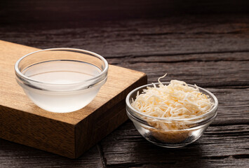 Cocos nucifera - Organic coconut water in glass bowl.