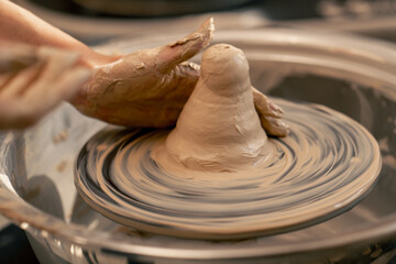 close up the clay modeling studio young girl hands giving shape to clay on a potter's wheel applied art clayware old craftsmanship