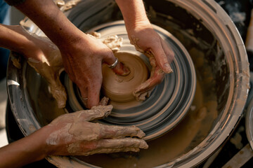 top shot close up the clay modeling studio young girl hands giving shape to clay on a potter's wheel applied art clayware old craftsmanship