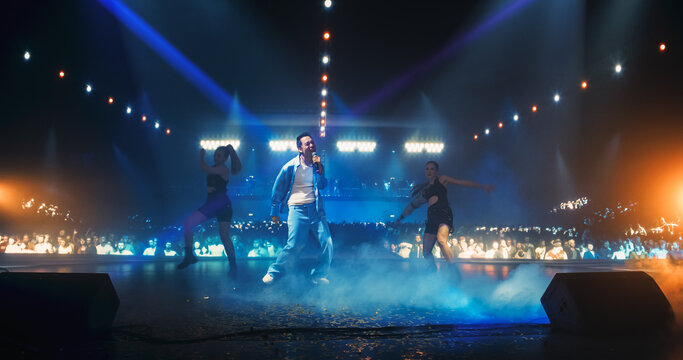 Portrait of a Male Singer Singing an Emotional Song. Spectacular Concert with a Talented Pop Star. His Soulful Voice and Catchy Tunes Keep the Audience Vibing to the Sounds of Modern Dance Music