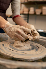 close up the clay modeling studio young girl hands giving shape to clay on a potter's wheel applied art clayware old craftsmanship teacher helps