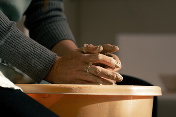 close up hands in clay modeling studio young girl hands giving shape to clay on a potter's wheel applied art clayware old craftsmanship mechanical potter's wheel