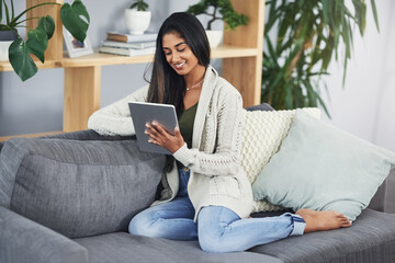 Sofa, woman and smile with tablet for scroll, online article and reading blog on education website. Home, female person and ebook with digital for social media, connection or relax on couch in lounge