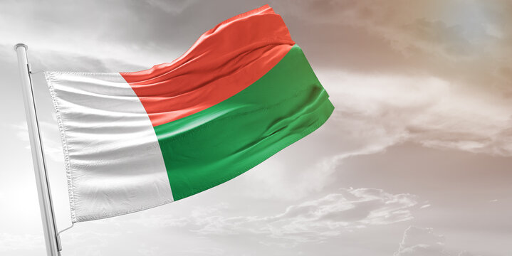 Madagascar national flag cloth fabric waving on beautiful grey Background. - Powered by Adobe