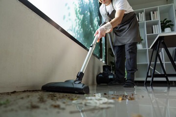 Professional Cleaner Vacuuming a Modern Office Space with Natural Light and Minimalist Decor