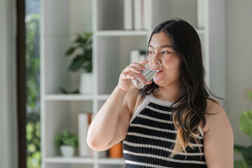 Healthy Lifestyle Concept Featuring a Woman Enjoying a Refreshing Glass of Water in a Modern Home Setting