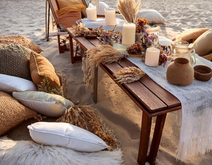 Bohemian-style beach picnic setup with cozy pillows, candles, and natural decorations, creating a relaxed and romantic atmosphere.