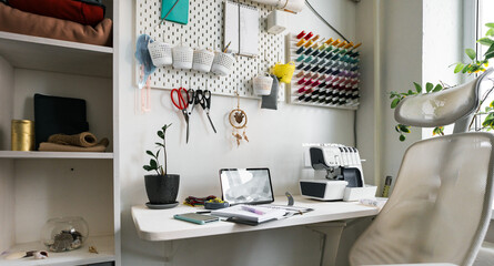 Organization of sewing space, where everything you need - fabrics, threads, needles, scissors, sewing machine - is always hand. Ergonomic arrangement of tools and accessories for productive work.