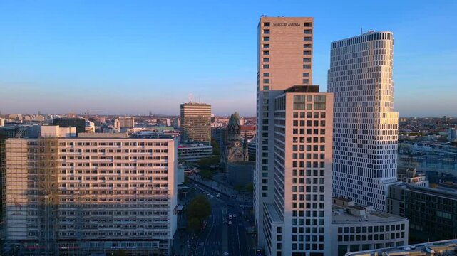 zoologischer garten train station and surrounding urban landscape in berlin, germany during sunset. Best aerial view flight fly reverse drone