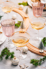 Traditional festive place setting for Christmas, glasses of sparkling wine