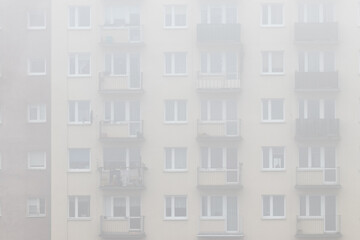 Residential building, multi-family skyscraper type in the fog