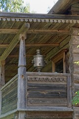 Obraz premium Mandrogi, Russia, July 11, 2024. An antique samovar on the porch of a wooden house. 