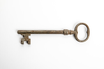 Black antique metal key on a white background
