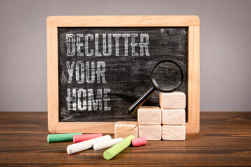 Declutter Your Home. Miniature chalkboard with text and magnifying glass