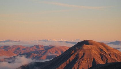 Naklejka premium mountains with a few clouds in the distance and a few snow capped peaks