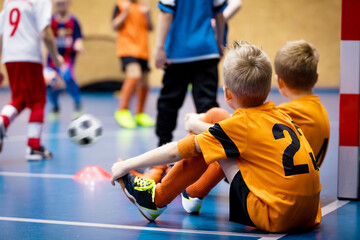Children in Futsal Training. Indoor Soccer Class for Kids at School Sports Hall. Children Kicking...