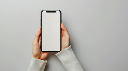 person holding smartphone with blank screen, showcasing modern technology and minimalism. hands are gently positioned, emphasizing clean aesthetic