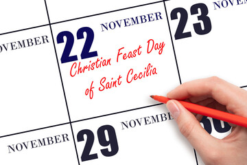 November 22. Hand writing text Christian Feast Day of Saint Cecilia on calendar date. Save the date.