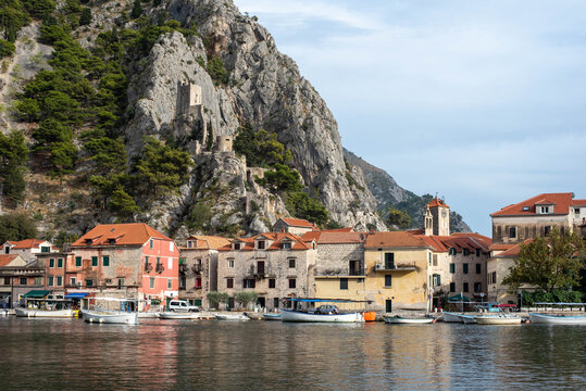 Fortress Peovica (Mirabela) overlooks Omis, Croatia, offering scenic views of the town, sea, and nearby mountains.