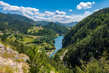 View of the mountain lake and wooded slopes