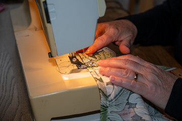 Woman working at home with sewing machine