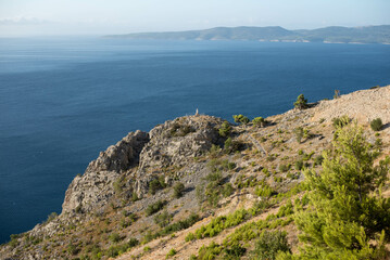 Seaside with cliffs and azure sea, Dalmatian region, Makarska Riviera, Croatia.