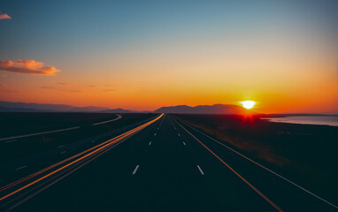 Naklejka premium Highway at Sunset with Red Brake Lights, Capturing the Solitude and Beauty of the Open Road