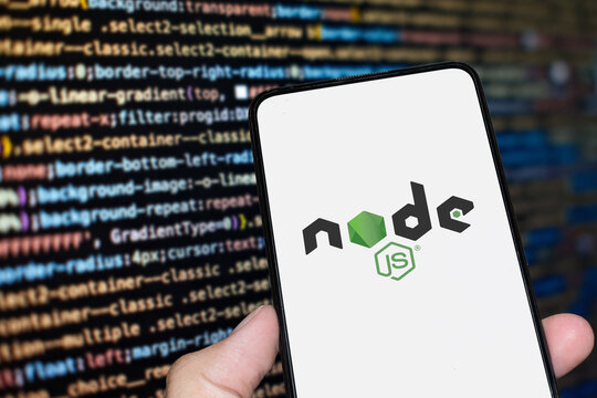 Node JS logo sign on the smartphone screen with code background. London, UK, 11.14.2024
