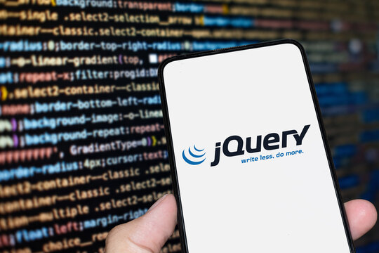 jQuery logo sign on the smartphone screen with code background. London, UK, 11.14.2024