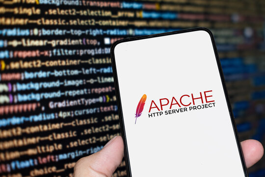 Apache logo sign on the smartphone screen with code background. London, UK, 11.14.2024
