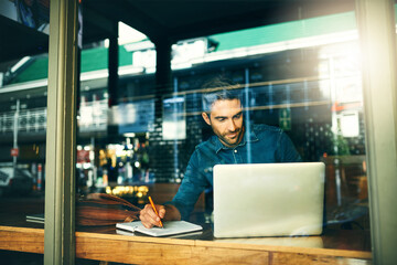 Laptop, window and businessman in cafe for writing notes, online research and planning project....