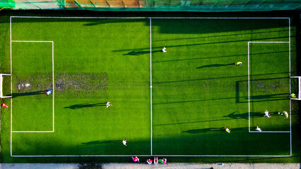 Aerial view of a soccer match on a bright green field. An aerial shot capturing a soccer match in...