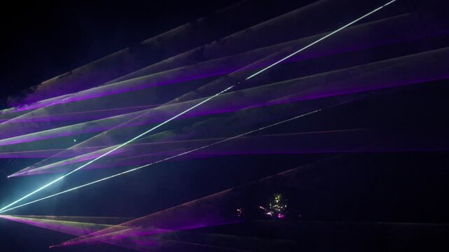 Futuristic laser beams dynamically crossing in a vibrant, abstract display of light and color. Lasershow with Multiple Laser Beams in High Quality 4K Video
