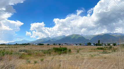 An amazing beautiful rural valley with mountains in the background. A summer landscape with green...