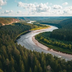 Obraz premium A serene mountain river flows through rugged terrain, surrounded by lush forests and towering peaks.