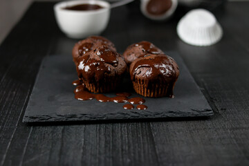 Chocolate muffins with sugar. on a gray background.dessert