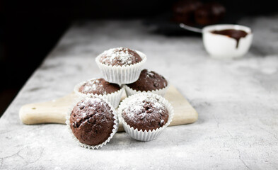 Chocolate muffins with sugar. on a gray background.dessert