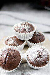 Chocolate muffins with sugar. on a gray background.dessert
