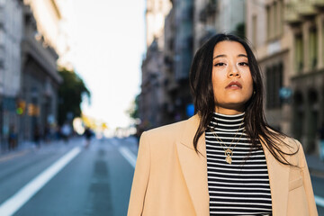 Fototapeta premium Confident young businesswoman posing in the city for a portrait