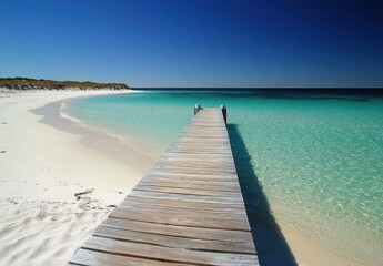Fototapeta premium Wooden Pier Leading into Turquoise Ocean from Beach