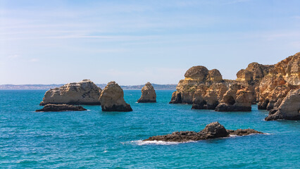 Stunning cliffs and rocks rise from Algarve’s blue sea, captured by drone on a sunny day