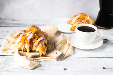 Bun, black coffee. on a light background. morning